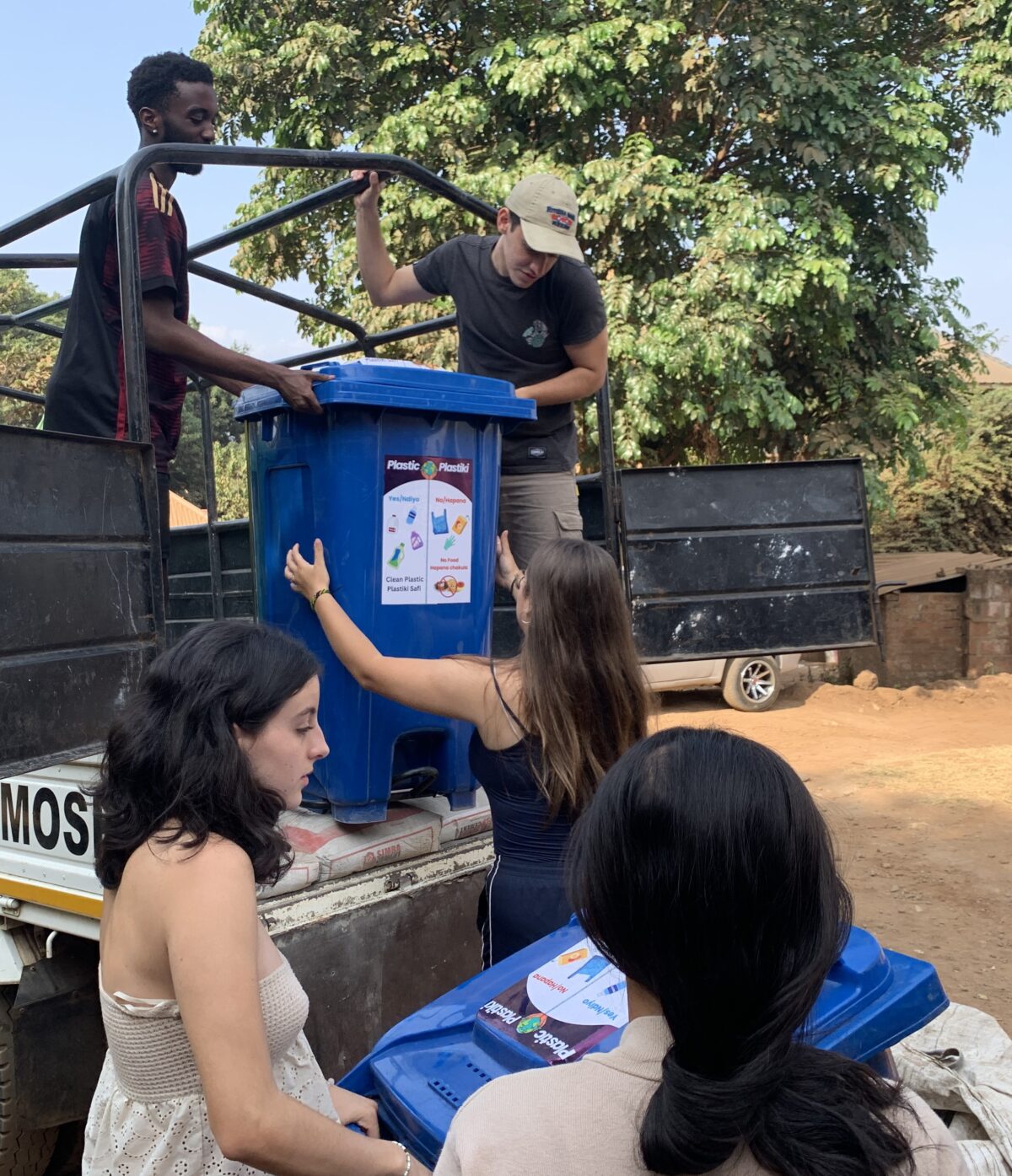 students unload recycling bins local plant